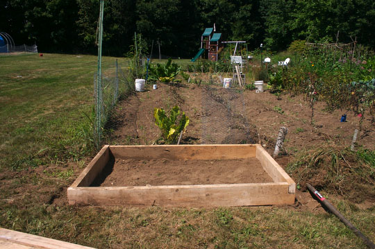 The raised bed, finished and ready to have the top and hoop attached.